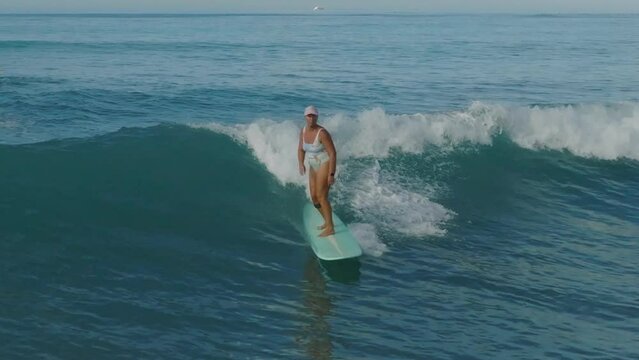 Mature Woman Surfer Surfing Ocean Waves 