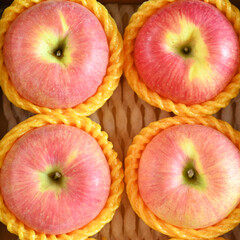 beautiful pink apple in yellow wrap bubble, healthy fruit in the box