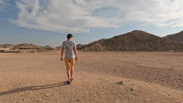 Young man walking in the Sinai Desert in Egypt at daytime