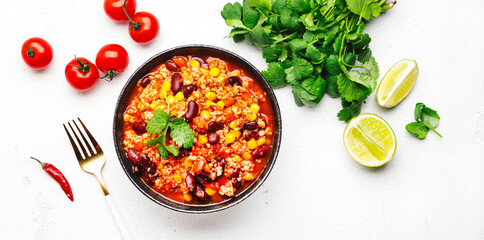 Chili con carne with beef, red beans, paprika, corn and hot peppers in tomato sauce, spicy tex-mex...