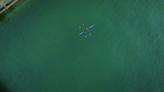 aerial top down of canoe kayak double couple seat rowing in stream green water river training for olympics game 