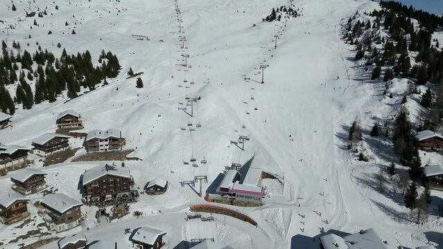 Winter resort Bettmeralp in the Aletsch Arena. Ski piste with skiers and chairlift. Beautiful weather and full ski slopes