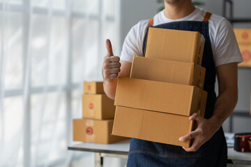 Small Business Startup Owner Asian Independent Entrepreneur Arranging multiple parcel boxes on...