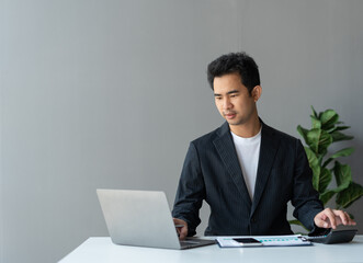 Asian businesswomen work using laptops and tablets, calculators to calculate make an account analysis report real estate investment information financial system concept and tax.