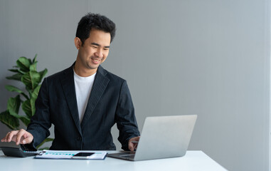 Asian businesswomen work using laptops and tablets, calculators to calculate make an account analysis report real estate investment information financial system concept and tax.