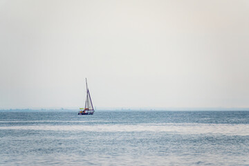 Fototapeta premium Sailing yacht in the blue calm sea.