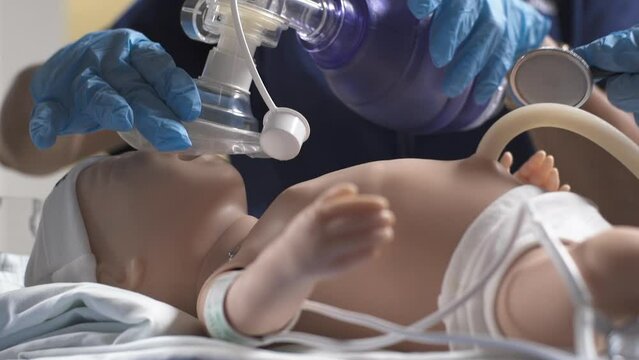 Nursing Student Practicing with Baby Mannequin