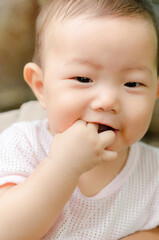 Portrait of a cute Asia baby boy Sucking fingers