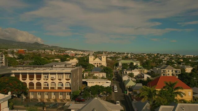 Drone flying High Up over St. Pierre in La Reunion filming south with Church in Background