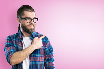 Happy young smart man posing on background