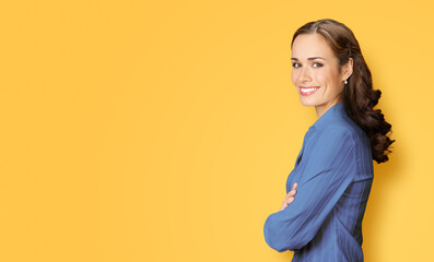 Portrait image of happy smiling young business woman standing profile side, folded hands, confident...