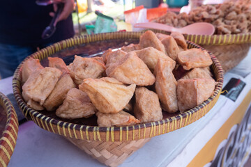 selective focus on piles of fried tofu filled with meatballs that are sold at culinary festivals, soft focus