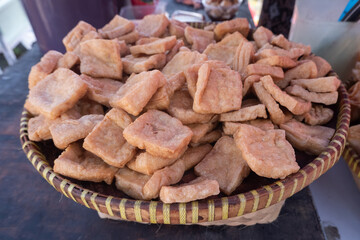 selective focus on pieces of fried tofu on a bamboo tray for sale at a culinary festival, soft focus