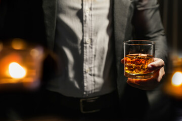 Closeup businessmen holding a glass of whiskey