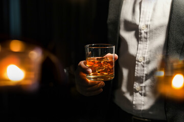 Closeup businessmen holding a glass of whiskey