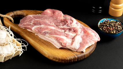 The concept of cooking meat. The chef cook salt on the cooked steak on a black background, a place under the logo for the restaurant menu. food background image, copy space text