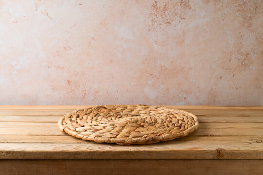 Wicker Place Mat On Wooden Table Over Stone Wall  Background. Kitchen Counter Mock Up For Design And Product Display