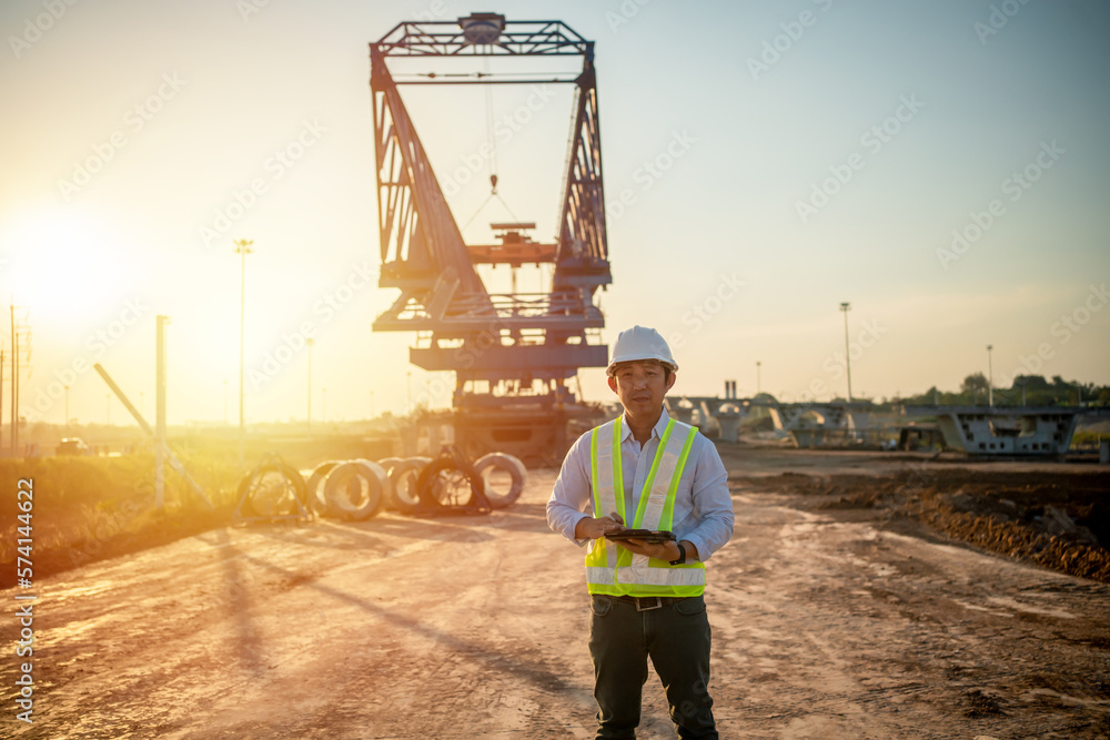 Aufkleber asian engineer with hardhat using tablet pc computer inspecting and working at construction site