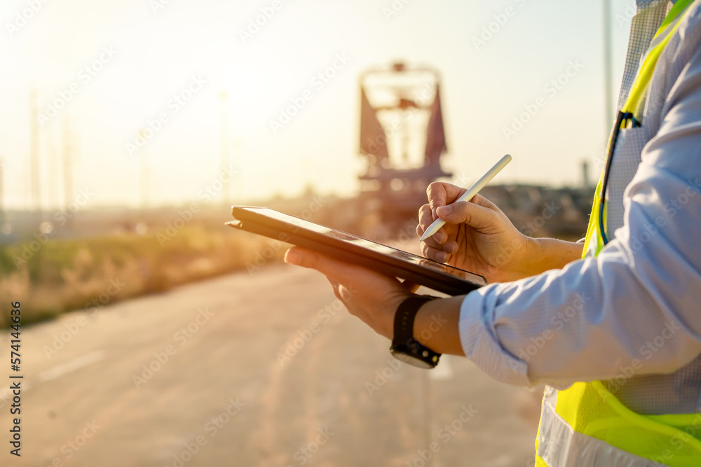 Aufkleber asian engineer with hardhat using tablet pc computer inspecting and working at construction site