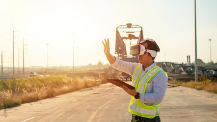 Asian engineer using virtual reality headset and tablet for inspecting and working at construction...