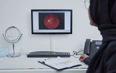 Eye analysis, optometry and a doctor with a computer for research on a retina and lens problem. Ophthalmology, technology and Muslim woman looking at a monitor screen for eyesight and optic analytics - obrazy, fototapety, plakaty