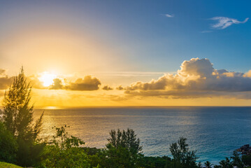 Fototapeta na wymiar Setting sun viewed from the top of Pointe Millers on Praslin island, Seychelles 