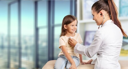 Young doctor checking small child