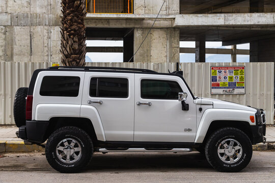 Side, Turkey - February  05, 2023:    white Hummer H3 is parked  on the street on a warm  day