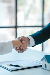 Shaking hands after sign a contract, realtor suggestion a new house model assisting client to sign...