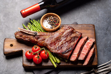 Medium rare grilled Tomahawk beef steak with asparagus