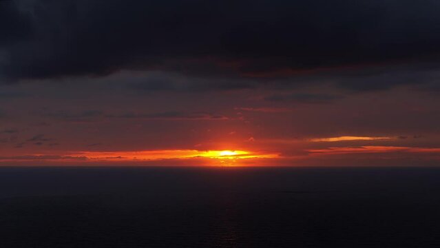 Orange sunset clouds over the sea