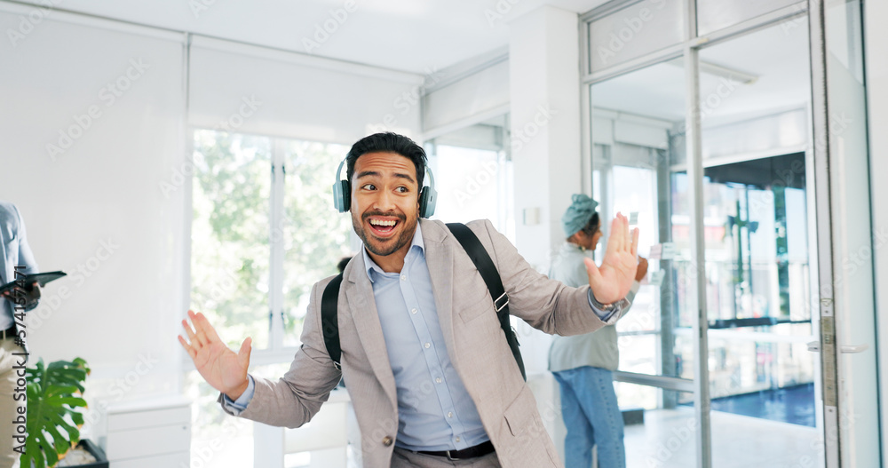 Wall mural Music, dance and motivation with a business man walking in an office while feeling positive or carefree. Success, happy or smile with a happy male employee arriving at work in headphones with a smile