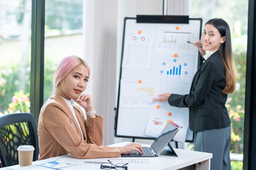 Businesswoman explaining marketing statistics to executive manager working together at company strategy during business meeting in startup office. Businesswoman planning partnership project