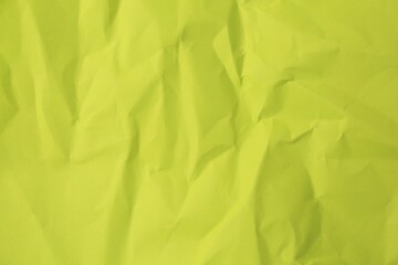 Sheet of crumpled light green paper as background, top view