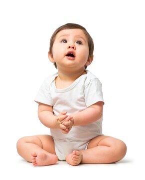Cute baby looking up in white onesie on white background