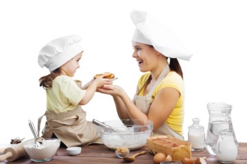 The beautiful young mother and her little daughter cook at home