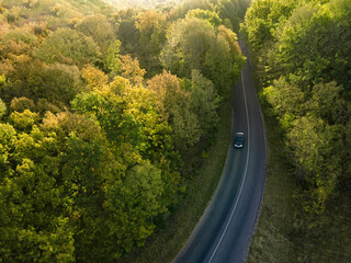 Aerial view on Highway road in the forest. View from a drone. Ca