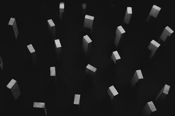 black and white abstract of wooden blocks standing in the dark sky. hike of everything
