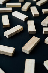 wooden blocks on a dark background, text to write. Jenga blocks.