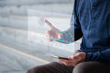 Hand of Businessman or trader touching showing a growing virtual hologram stock , Concept invest in trading.planning and strategy, Stock market, Business growth, progress or success concept.