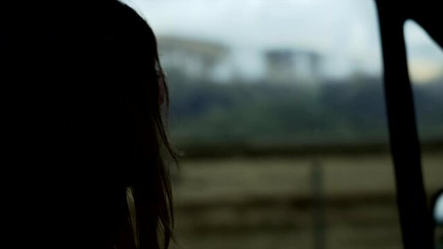 Unrecognizable Woman Looking Out Of The Car Window At The Scenery