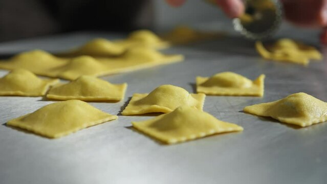 Ravioli Pasta Cut. Preparing ravioli with ricotta. Chef man prepare fresh made ravioli inside pasta factory
