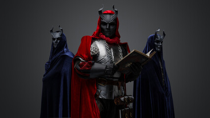 Naklejka premium Portrait of two members of mysterious cult and their chief with book.