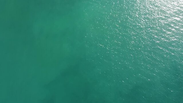 Enjoy a spectacular 4K drone view of world's ocean and beaches on a sunny day.