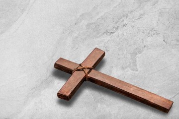 Wooden christian cross on stone desk