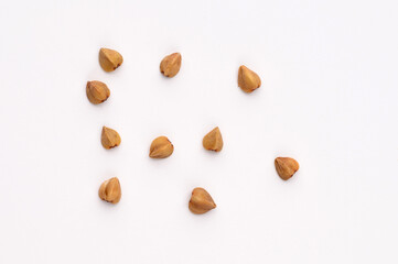 Close-up, macro of buckwheat on a white background.Hypoallergenic pillow filling. Prevention of anemia.