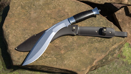 Kukri knife and leather scabbard lying on a stone. 3D rendering