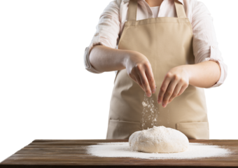 Hands cooking homemade bread dough on wooden table