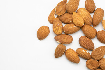 Almonds with golden roasted texture crust, close-up on a white background