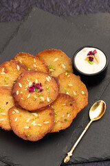 Juicy Sugary Pancakes Sweets Also Called Malpua, Pooa Or Pua Are Traditional Indian Dessert Mithai Drenched, Dunked, Soaked Or Dip In Sugar Syrup Cheeni Ki Chasni. Enjoyed On Holi, Navratri and Diwali